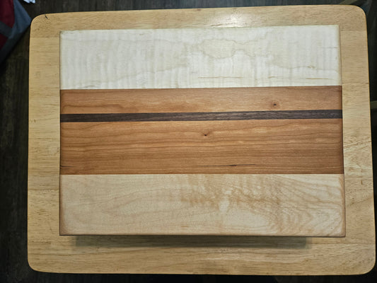 Cutting/Vegetable Board made w/ Walnut, cherry and Maple with finger grips 12" x 9"